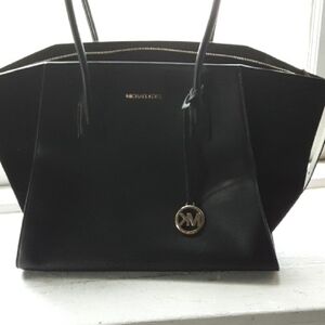 Black Trapezoid Tote with Long Handles and Metallic Charm